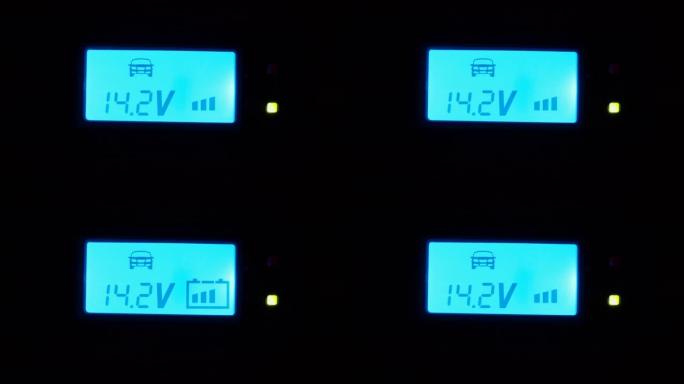 汽车电池充电器显示电压，电池电量闪烁-蓝色发光二极管显示特写