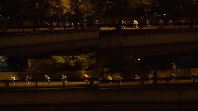 骑自行车的人在城市的中心街道上进行夜间比赛，