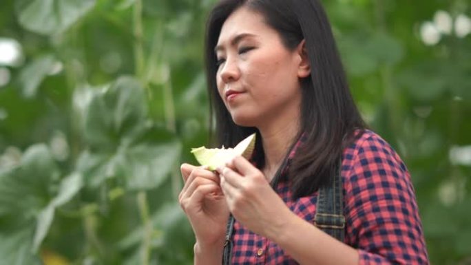亚洲年轻女农场主测试和嗅闻瓜类作物品种进行研发，转基因食品，生物食品概念