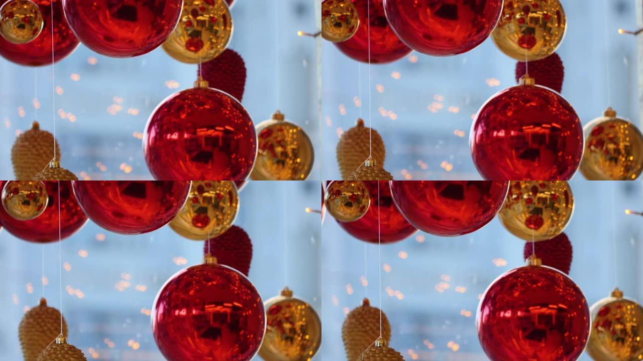 圣诞节和新年装饰。夜光灯笼和金色花环背景上的圣诞节大红球。假日背景。闪烁的花环。红色小玩意，灯光闪烁