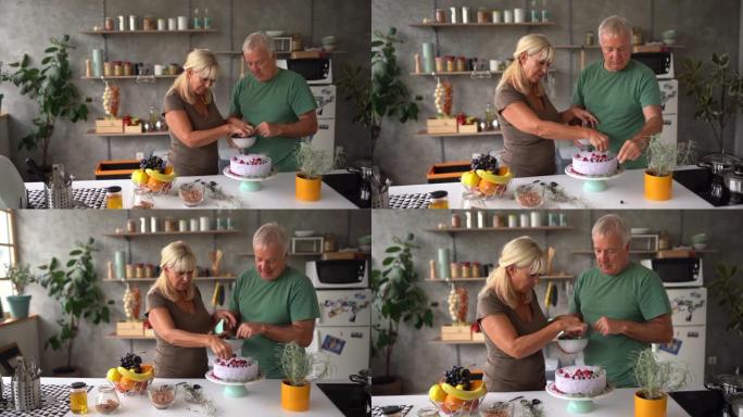 高级夫妇在家用浆果水果装饰生日蛋糕