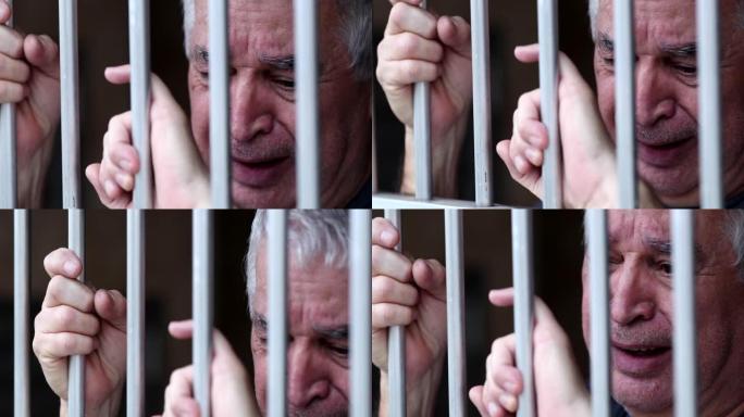 绝望的陷入困境的老人在监狱里哭泣