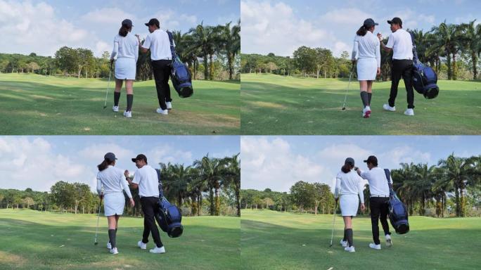 在夏日阳光明媚的日子里，一对幸福的夫妇穿着高尔夫球服，背着装有专业球杆的站立包走向高尔夫球场，有着健