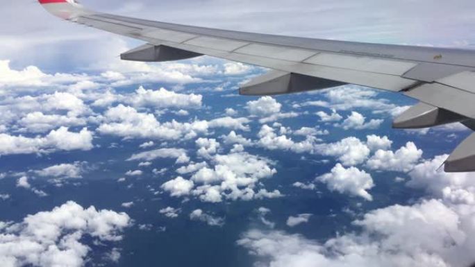 用手机拍摄，从飞机的窗户看，从飞机的窗户看，云彩和天空。4k分辨率b-roll。