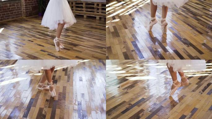 穿着白色芭蕾舞鞋和裙子的年轻芭蕾舞演员在木地板上练习芭蕾舞。穿着白色脚尖鞋的年轻芭蕾舞演员在芭蕾舞学