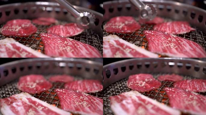 4k日式银色金属包拿起牛肉片放在烧烤架上，做得很好，中等稀有肉，煤火，日本餐厅，火焰烤，白盘，主菜
