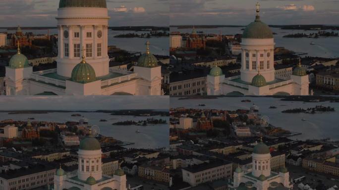 赫尔辛基大教堂的鸟瞰图和日落时带有港口和摩天轮的城镇景观