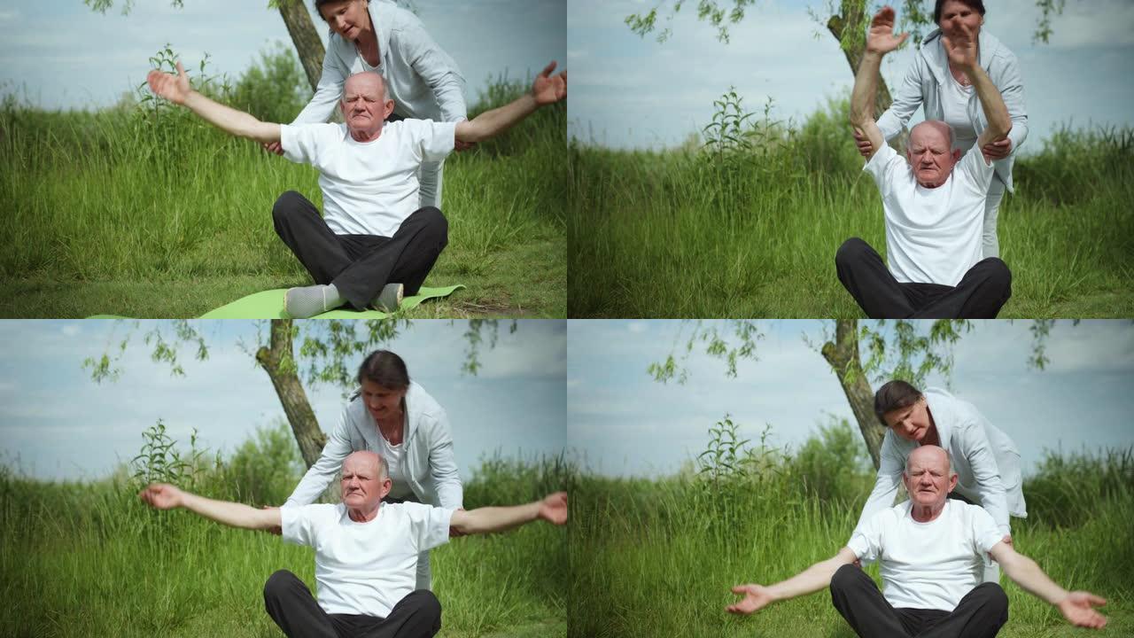 医疗保健，老年妇女和男性养老金领取者过着运动的生活方式，并在晴天坐在空旷地区的瑜伽垫上进行体育锻炼