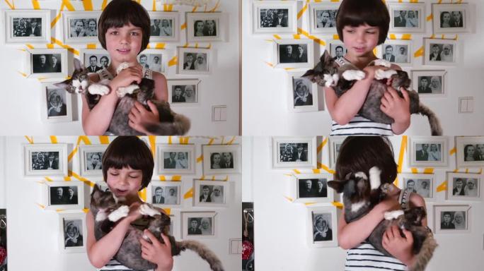 一个抱着猫的男孩在家谱的背景照片下摆姿势
