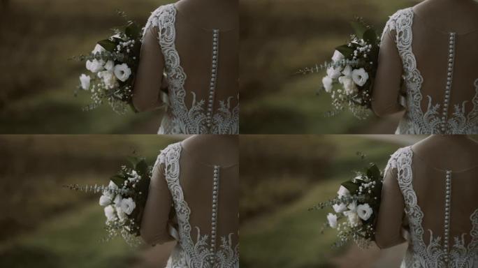 农村新娘礼服和花束的特写镜头。