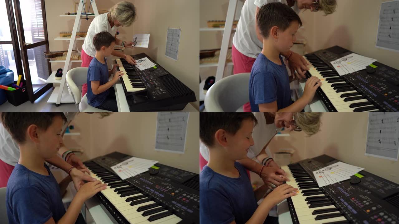 康复中心的音乐治疗师和男孩演奏合成器