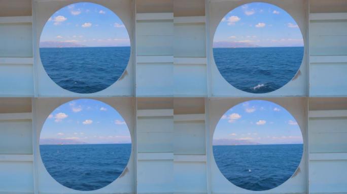 游艇圆窗的夏季海景。水运。旅游概念。从邮轮的船舱可以看到大海。通过船的舷窗观看日落和海洋