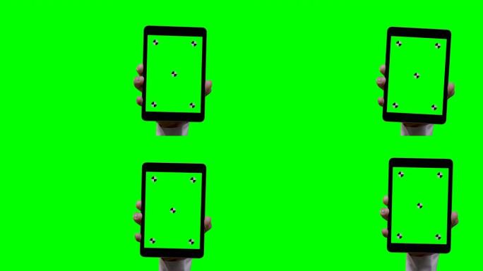 智能手机上的绿色屏幕和背景跟踪点的人手持平板电脑进入屏幕右侧