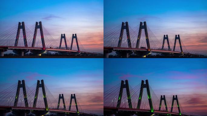 日落时，波兰克拉科夫维斯瓦河上具有纪念意义的，照明的新型现代双斜拉桥。过度，延时视频。