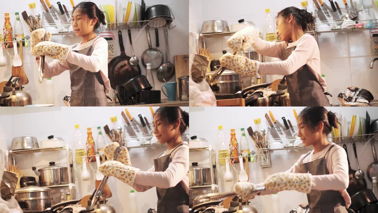 亚洲女孩穿着围裙和手手套在家自己做薯条前，生活方式理念。