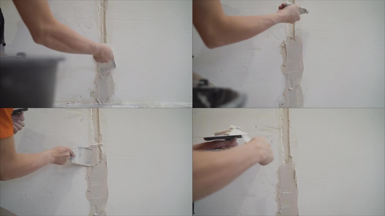 手抹灰在工作。把灰泥涂在墙上。纹理的石膏。贴在墙上。