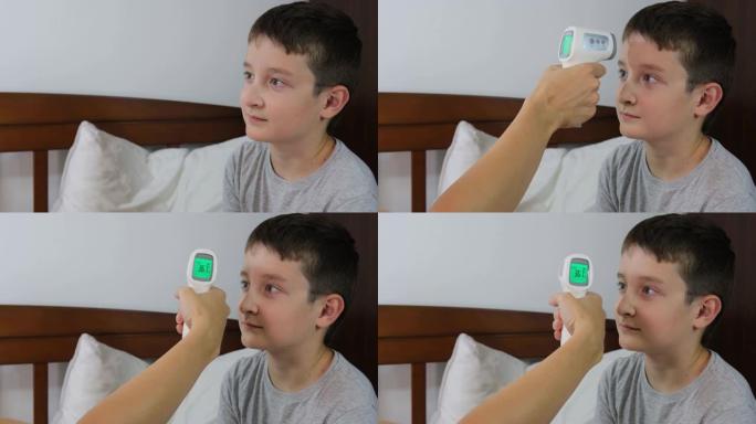 一个正常体温的康复男孩，显示在红外非接触式温度计的显示屏上，即健康儿童的概念