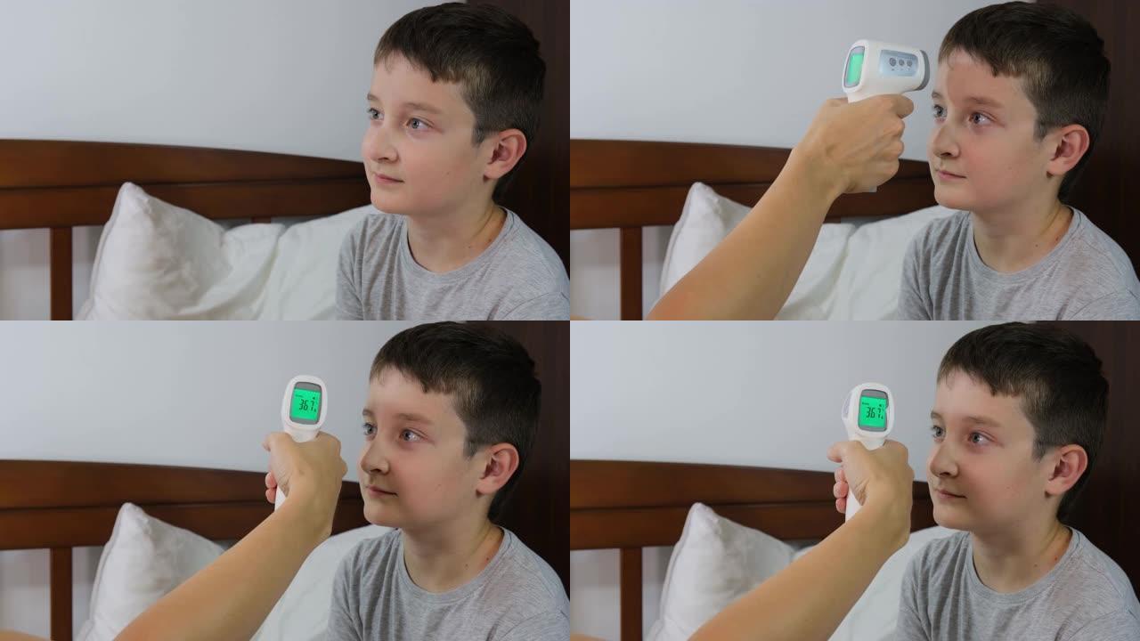 一个正常体温的康复男孩，显示在红外非接触式温度计的显示屏上，即健康儿童的概念