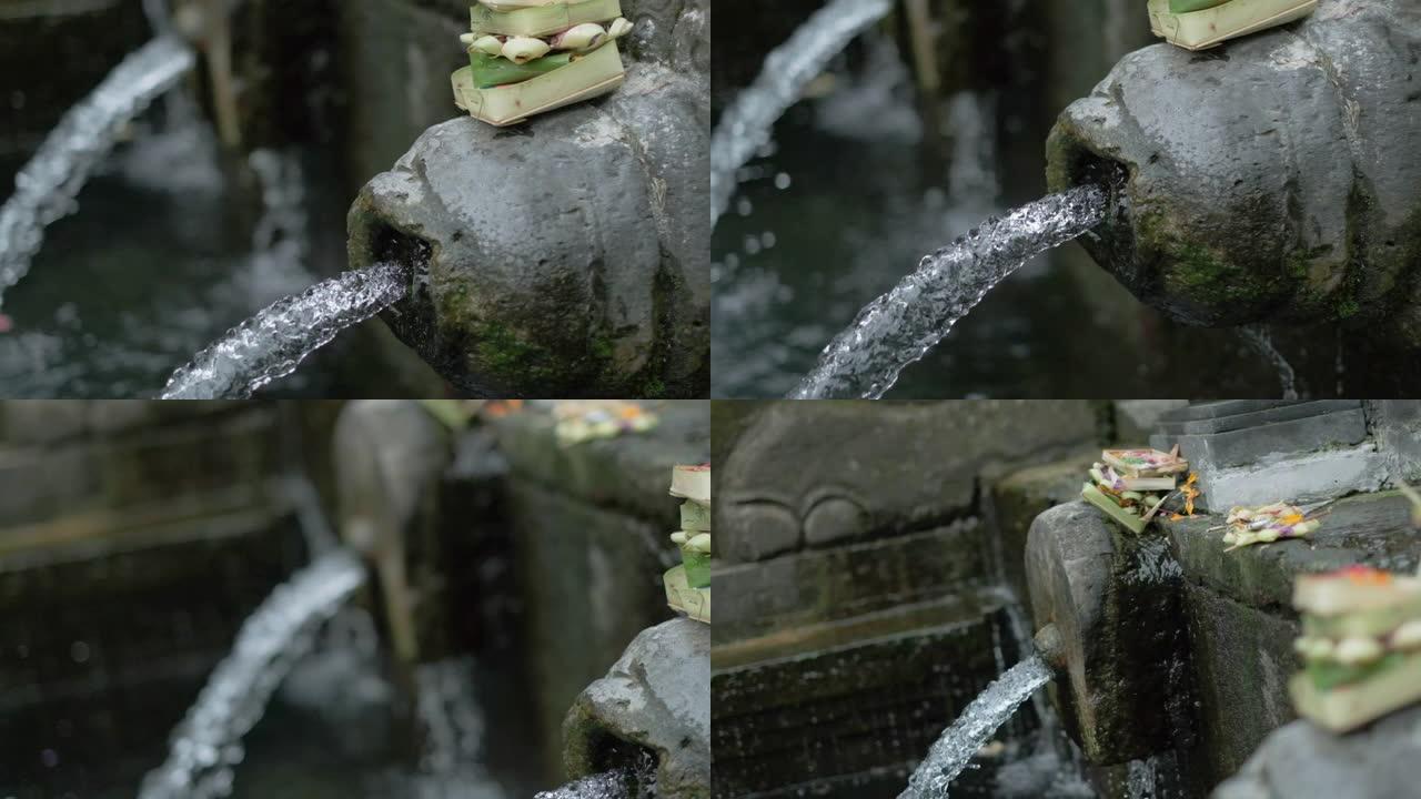 印度尼西亚巴厘岛沐浴喷泉上的熏香，慢动作。