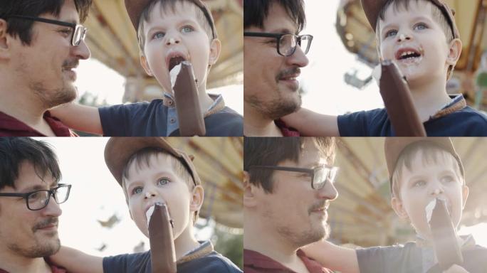 父亲和孩子在游乐园吃冰淇淋