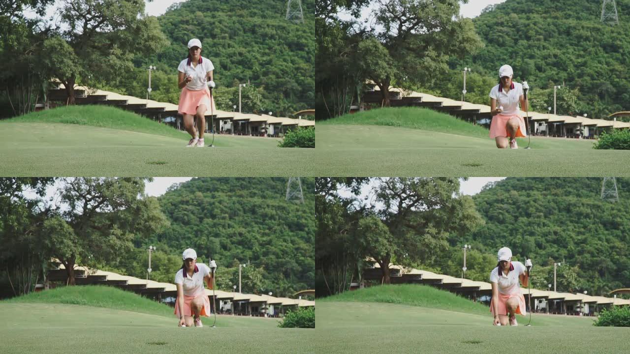 女高尔夫球手将球放在绿色上的镜头，视频慢动作