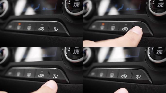 按下用于切换汽车空调运行模式的按钮的特写。男人的手转动按钮，调节车内的舒适性