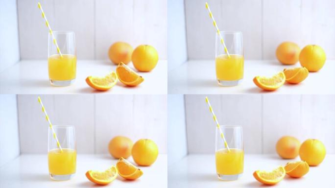 橙色鲜果汁，白色背景下的水果，生动的橙色细节。健康和生态电影