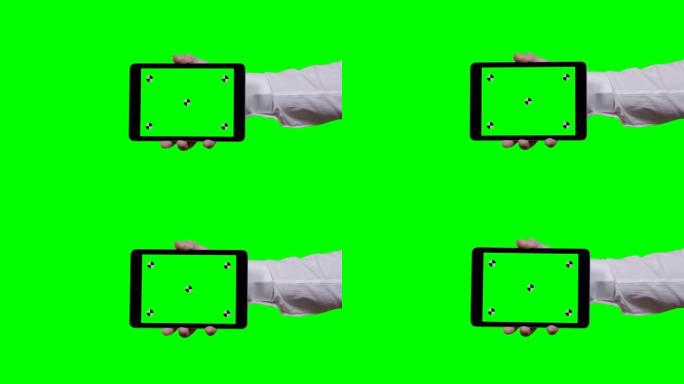 男人的手拿着平板电脑水平，绿色屏幕在前景和智能手机上的背景跟踪点从右侧进入屏幕屏幕