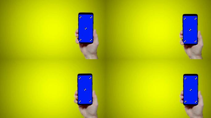 黄色背景上带有蓝色croma关键跟踪点的男子手持智能手机进入屏幕右侧
