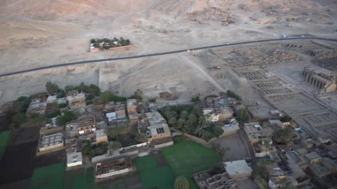 从热气球上鸟瞰Medinet Habu神庙与国王谷天际线背景的埃及卢克索