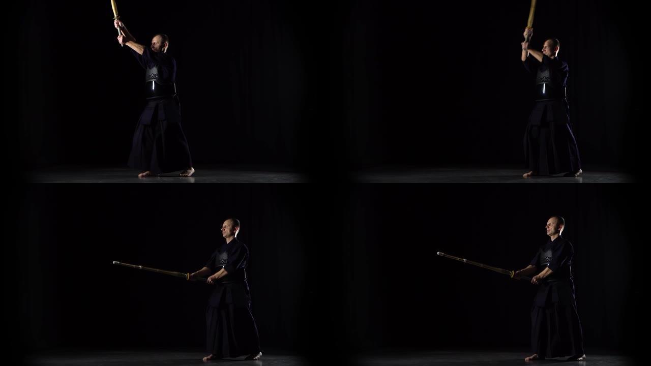 男性剑道战士在黑色背景上练习武术