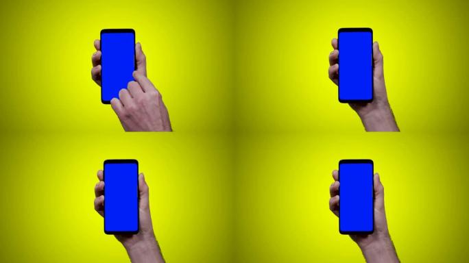 男子手持智能手机，黄色背景上的蓝色croma键向左侧滑动一次