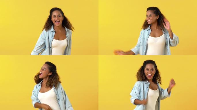 可爱的快乐非洲裔美国女人在黄色背景上跳舞