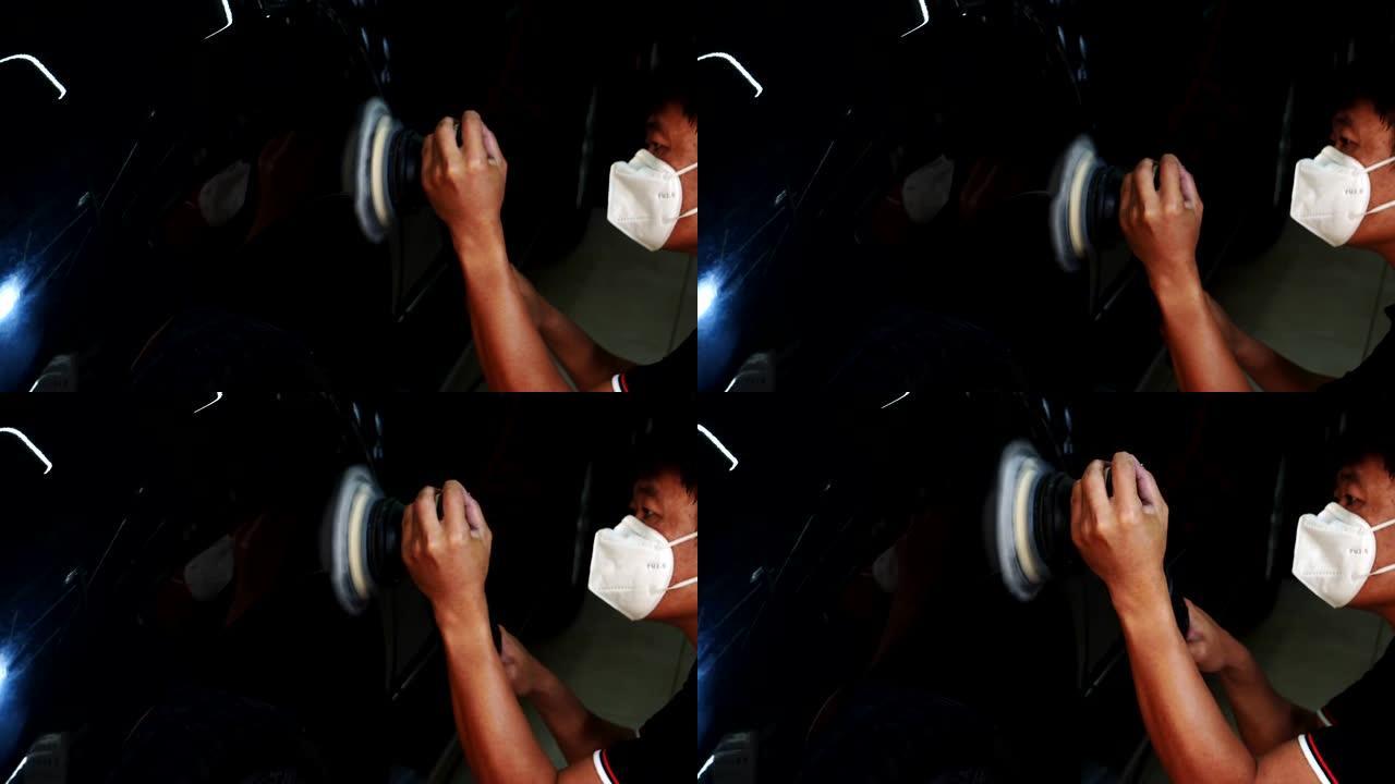 汽车细节-男士正在使用机械汽车抛光机维护去除痕迹根据汽车油漆的表面修复，然后继续涂覆陶瓷