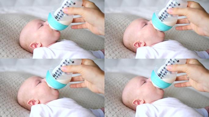 喂养婴儿。婴儿吃奶瓶里的牛奶。母亲喂养她刚出生的婴儿。