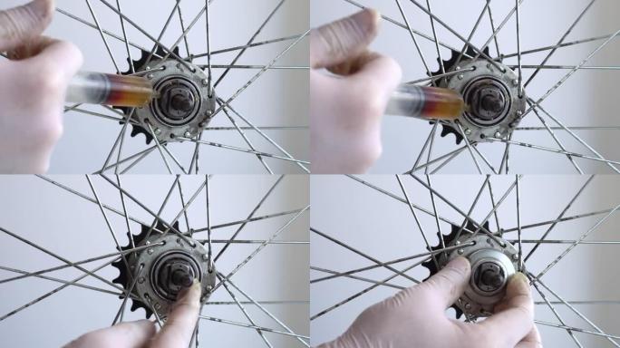 自行车车轮后套筒的组装。视频特写在后轮毂上涂抹润滑脂。