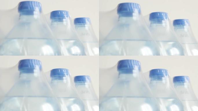 包装瓶装水特写倾斜镜头-透明液体缓慢倾斜的宠物容器