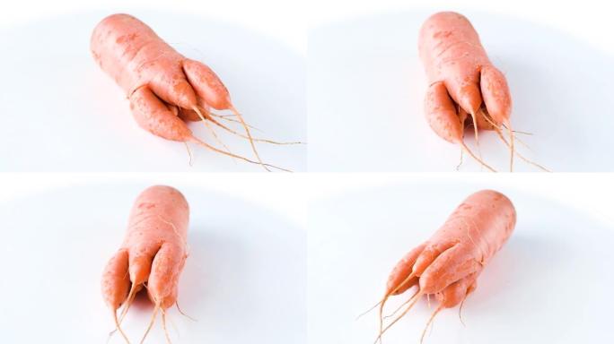丑陋的胡萝卜在白色背景上旋转。有趣，不正常的蔬菜或食物浪费概念。水平方向