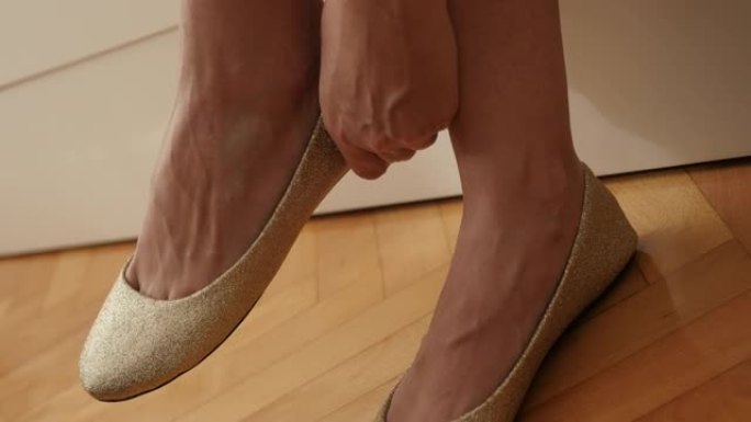 女人正在尝试金色芭蕾平底鞋4K