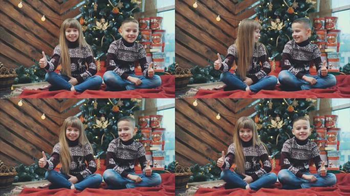 穿着深红色羊毛衫的高加索兄弟姐妹竖起大拇指，对新年气氛感到满意。