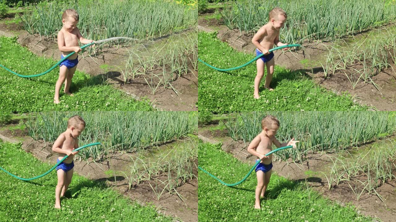 有趣的小男孩玩花园软管