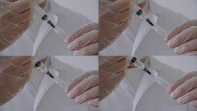 特写医用手套用注射器针头从安瓿中吸食药液。医务工作者准备注射抗病毒疫苗。医用液体药物和维生素