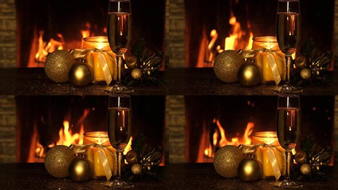 圣诞球，蜡烛，一杯香槟和在壁炉附近的桌子上落下的小火花