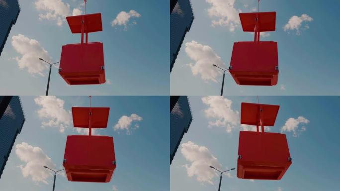 起重机举起的橙色建筑摇篮的特写镜头提升到摩天大楼