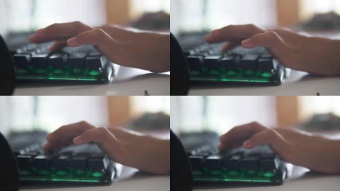 孩子的手用键盘电脑在家玩网络游戏，生活方式概念。