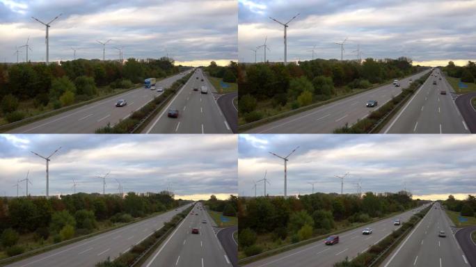 背景为风力涡轮机的德国高速公路上的交通