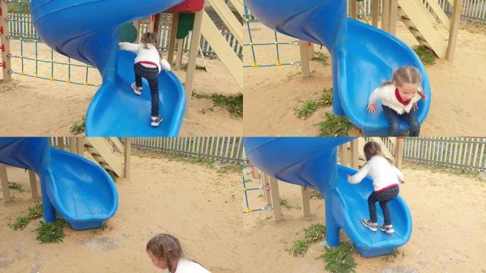 一个小女孩在儿童公园里骑着滑梯，举起检疫