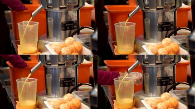 榨汁机装置正在制作新鲜的橙汁