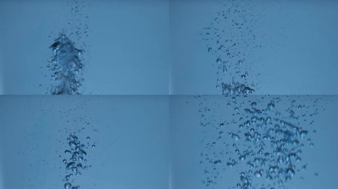 慢动作。水下气泡的抽象运动。旋转的气泡在蓝色水中喷射。特写。