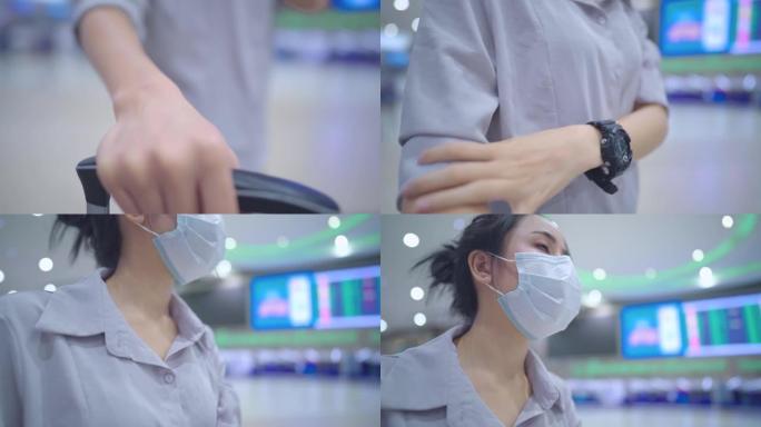 年轻女子在机场内戴口罩，在空荡荡的机场航站楼时间表大屏幕内，新型冠状病毒肺炎大流行期间的旅行风险，新